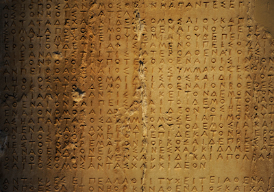 A slab on display at the Acropolis Museum in Athens shows decrees written in the Greek alphabet around 446 B.C. (Universal History Archive/Universal Images Group/Getty Images)